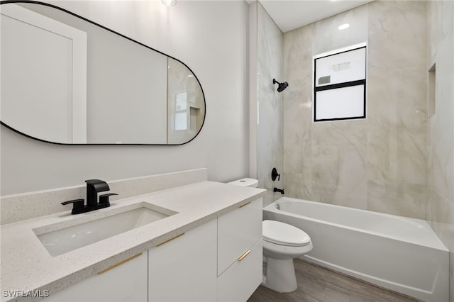 full bathroom featuring hardwood / wood-style flooring, vanity, toilet, and bathing tub / shower combination