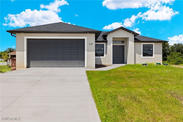 view of front of property featuring a garage and a front lawn