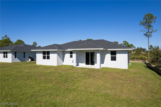 rear view of property featuring a yard