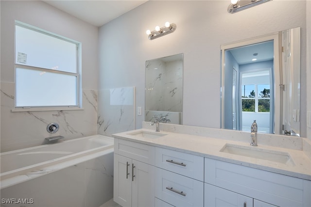 bathroom featuring a washtub and vanity