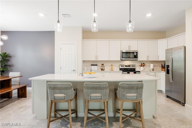 kitchen featuring white cabinetry, tasteful backsplash, visible vents, and appliances with stainless steel finishes