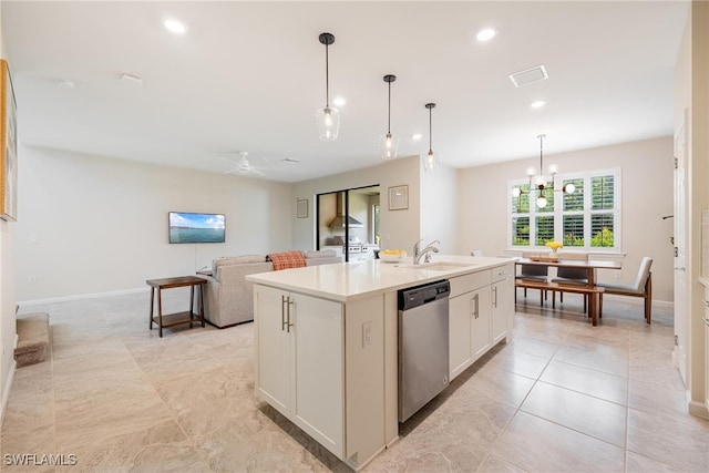 kitchen featuring dishwasher, sink, white cabinetry, a center island with sink, and decorative light fixtures