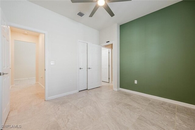 unfurnished bedroom featuring baseboards, visible vents, and ceiling fan