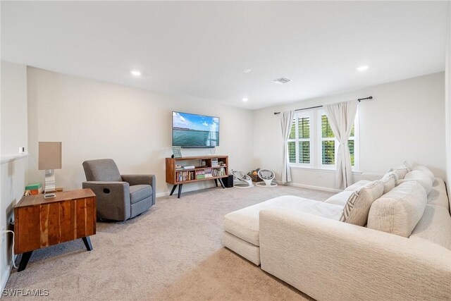 living room with recessed lighting, visible vents, baseboards, and carpet