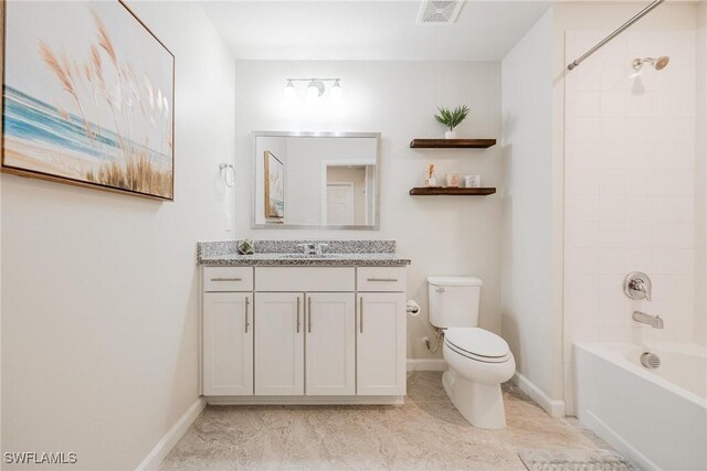 full bathroom featuring tile patterned floors, tiled shower / bath combo, vanity, and toilet