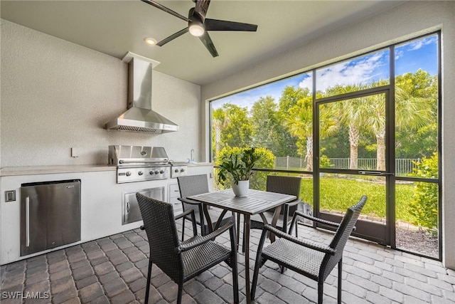 sunroom featuring ceiling fan