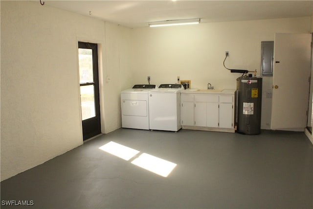 interior space with electric panel, sink, cabinets, washing machine and dryer, and water heater