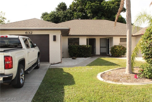 ranch-style house with a garage and a front lawn