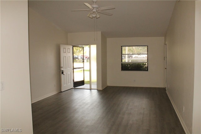 empty room with dark hardwood / wood-style flooring, ceiling fan, and plenty of natural light