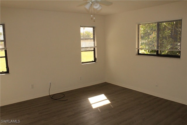 spare room featuring ceiling fan and dark hardwood / wood-style floors