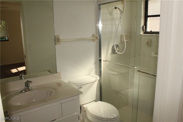 bathroom with walk in shower, vanity, and toilet