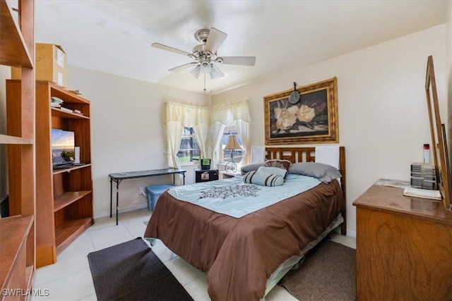 bedroom featuring light tile patterned flooring and ceiling fan