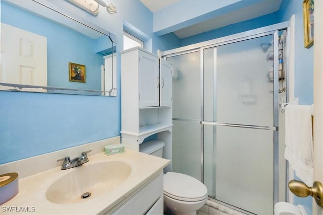 bathroom with toilet, an enclosed shower, and vanity