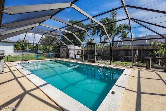 view of pool featuring a patio, a lanai, and a storage unit