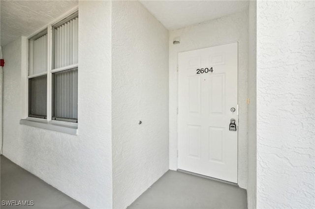 entrance to property with stucco siding