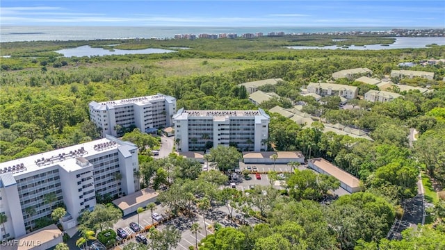 aerial view with a wooded view and a water view