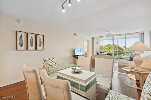 dining space with hardwood / wood-style floors, ceiling fan, and expansive windows