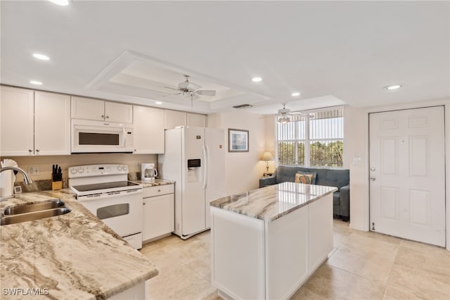 kitchen featuring ceiling fan, sink, white appliances, a kitchen island, and white cabinetry