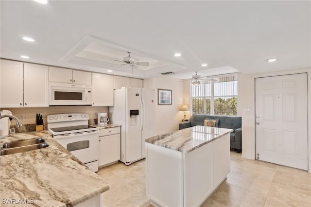 kitchen featuring a kitchen island, recessed lighting, white appliances, a ceiling fan, and a sink