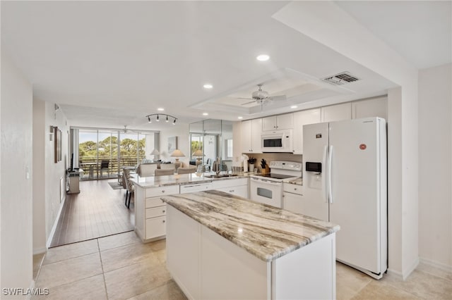 kitchen with ceiling fan, white cabinets, kitchen peninsula, and white appliances