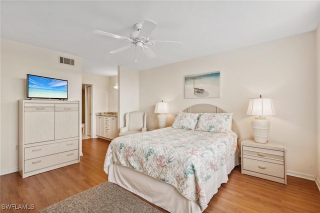 bedroom with ceiling fan, visible vents, baseboards, and wood finished floors
