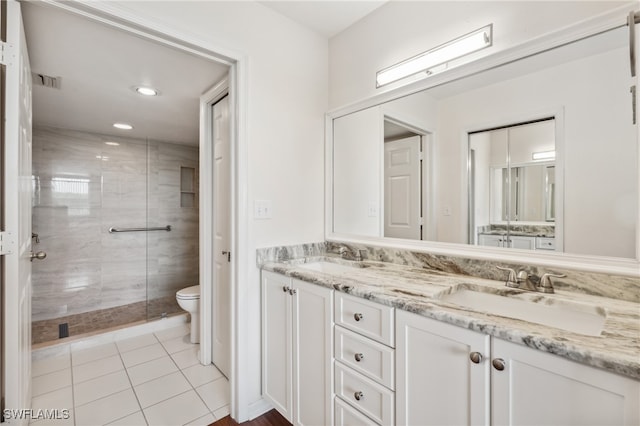 bathroom with vanity, tile patterned floors, a shower with shower door, and toilet