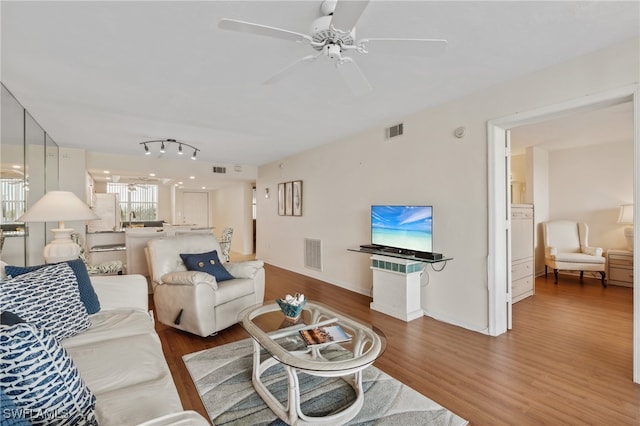 living room with ceiling fan and hardwood / wood-style flooring