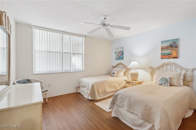 bedroom with wood-type flooring and ceiling fan