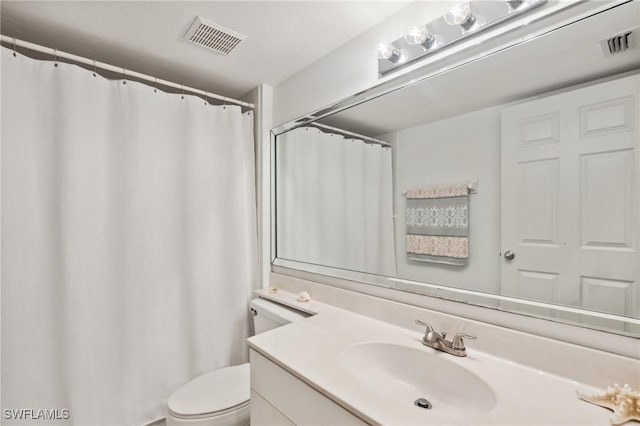 bathroom with visible vents, toilet, and vanity
