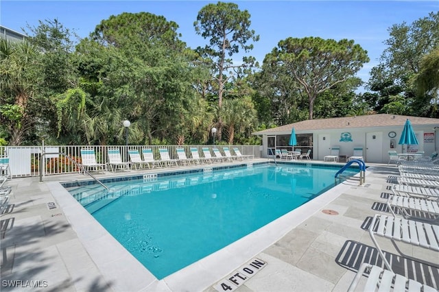 community pool featuring a patio area and fence