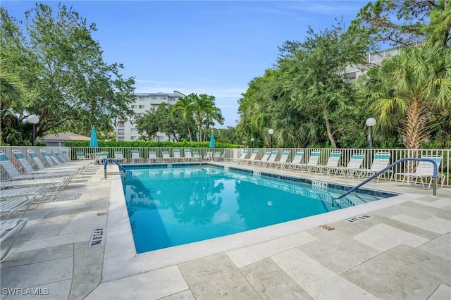 community pool featuring a patio area and fence