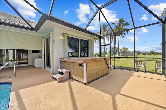 view of patio with a lanai and a hot tub