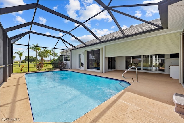 view of swimming pool with a lanai and a patio