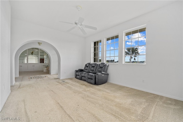 unfurnished room featuring ceiling fan and light colored carpet