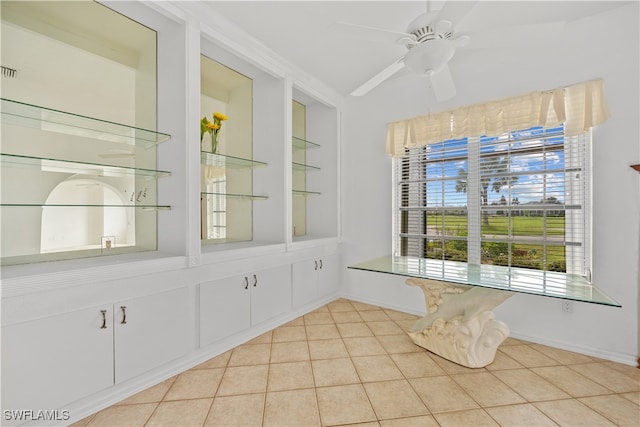 empty room with light tile patterned flooring and ceiling fan