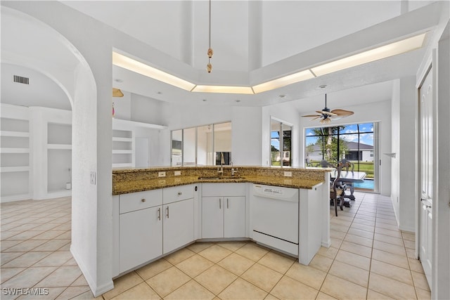 kitchen featuring light tile patterned flooring, dishwasher, ceiling fan, and white cabinets