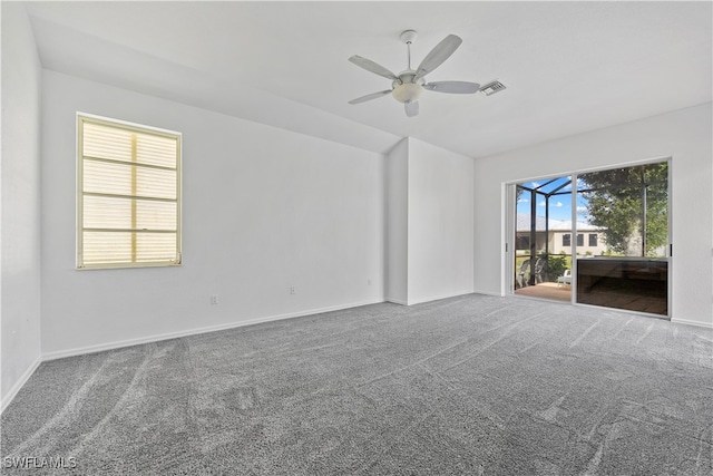 carpeted spare room featuring ceiling fan