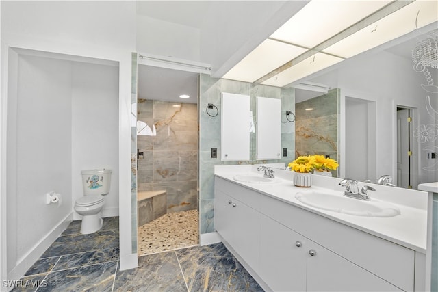 bathroom featuring tiled shower, vanity, and toilet