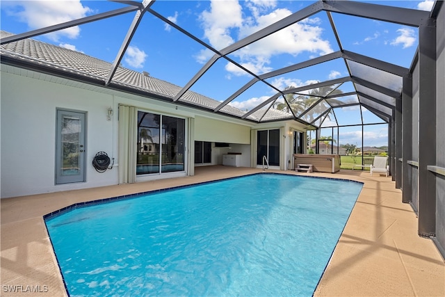 view of swimming pool with glass enclosure and a patio area