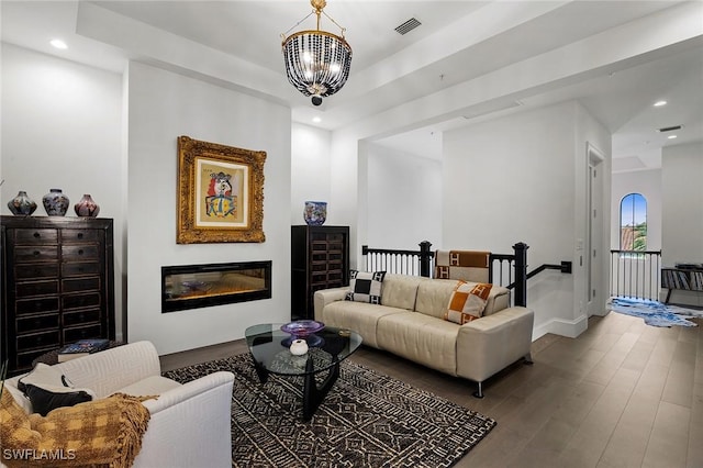 living room with a chandelier and wood-type flooring