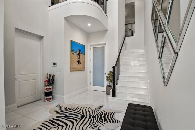 entrance foyer featuring a high ceiling and light tile patterned flooring