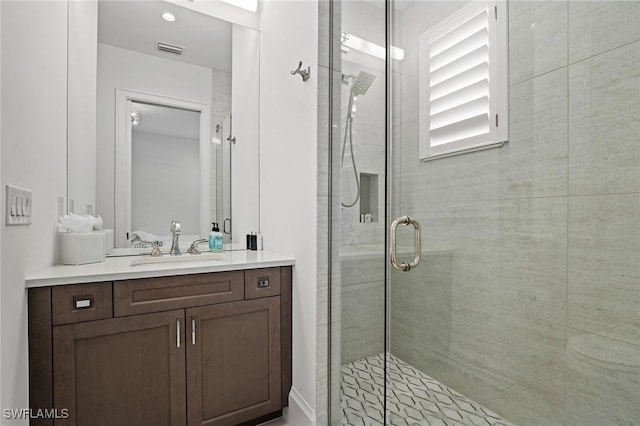 bathroom featuring vanity and an enclosed shower