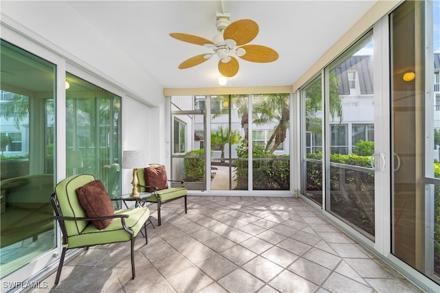 sunroom / solarium featuring ceiling fan