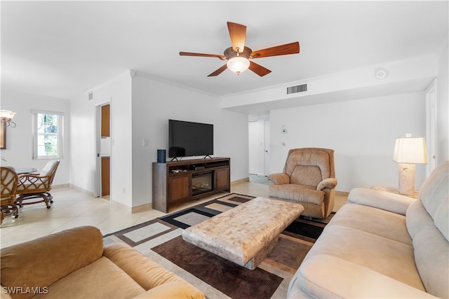 tiled living room with ceiling fan and ornamental molding