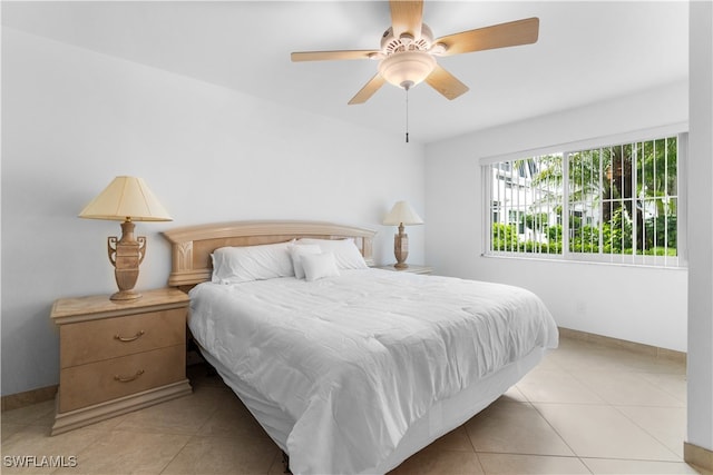 tiled bedroom featuring ceiling fan