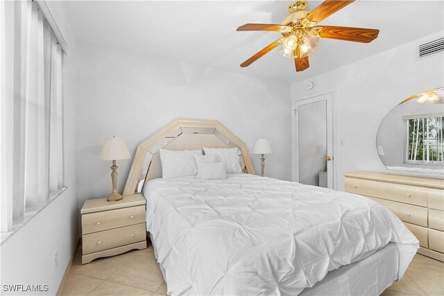 bedroom with ceiling fan and light tile patterned floors