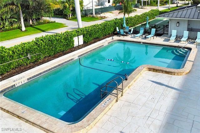 view of swimming pool with a patio