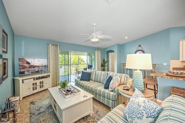 living room featuring recessed lighting, arched walkways, and ceiling fan