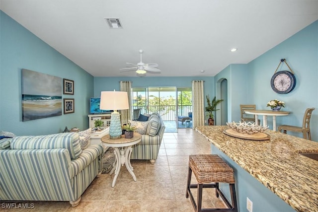 living area with visible vents, a ceiling fan, recessed lighting, light tile patterned floors, and lofted ceiling