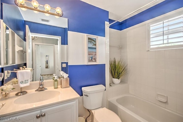 bathroom with vanity, toilet, tub / shower combination, and visible vents